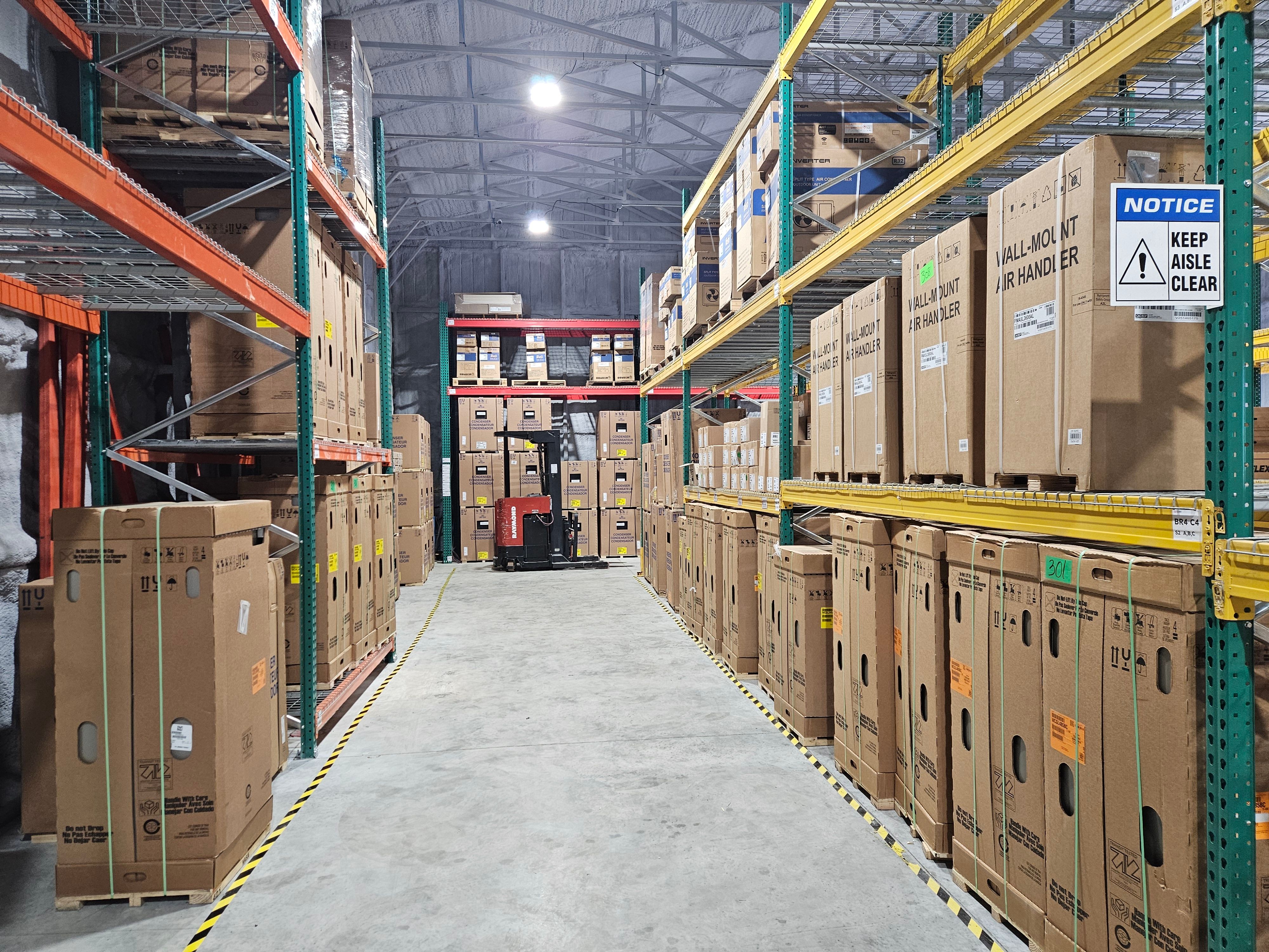 A SESupply warehouse aisle lined with stocked pallet racking