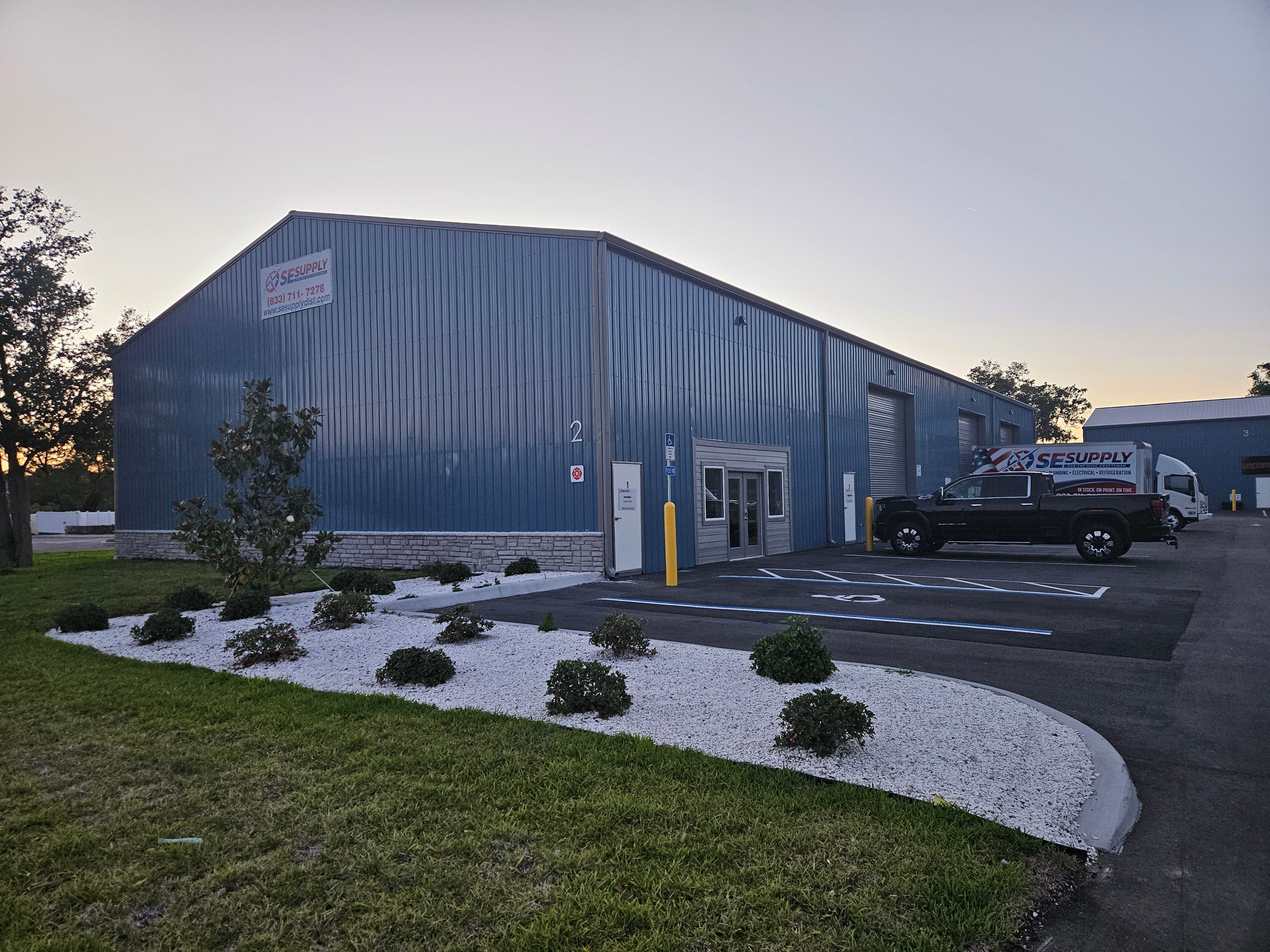 The SESupply building in Edgewater, Florida at dusk with the branded delivery truck out front